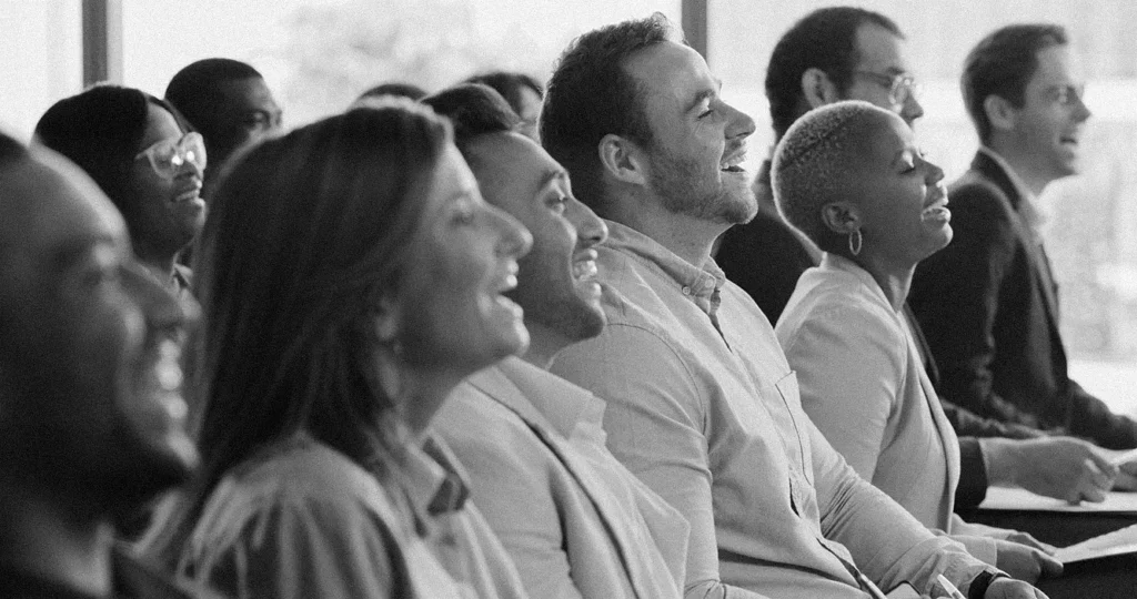 A happy professional audience laughing.
